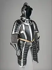 Black painted suit of German armor crafted circa 1600. As with many outfits, black in the piece is used to contrast against lighter colors.