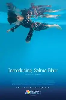 An underwater shot of woman in dress floating face down in a swimming pool