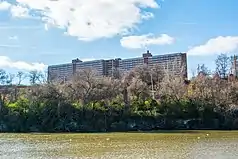 a river, a hillside, and a high-rise building