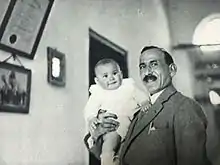 Palestinian journalist Issa El-Issa holding his daughter Raja in Jaffa.