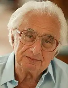 Elderly, clean-shaven man with spectacles and white hair