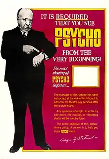 A large image of Hitchcock pointing at his watch. The words at the other side of the poster read, in part, "It Is Required That You See Psycho From the Very Beginning!" There is a space for theater staff to advertise the start of the next showing.