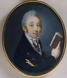 Portrait of a young man with gray hair in a double-breasted, buttoned suit holding a book in his right hand.