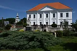 The former Premonstratensian monastery with the tower of the Roman Catholic church in the background