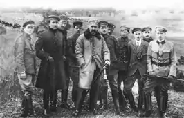 A black-and-white photograph of several men grouped together and looking forward