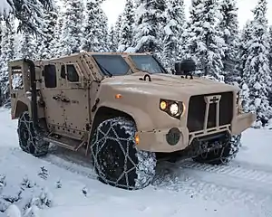 A production standard USMC JLTV in M1280 General Purpose (GP) configuration, this example fitted with a deep fording kit and tire chains.