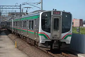 An E721 series train pulling into Nagamachi Station on the Tōhoku Main Line