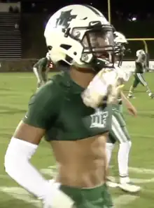 Hyatt in high school wearing his helmet on a football field