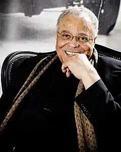 James Earl Jones sitting in a chair smiling at the camera in 2010