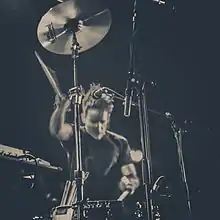 Jamie Stewart playing drums