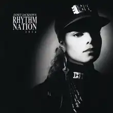 A young woman photographed in black and white wears an all-black, military-styled uniform accented by silver-plated accessories. A spotlight shines on her face. To her left reads the text "Janet Jackson's Rhythm Nation 1814".