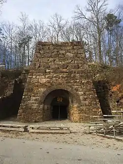Photo shows an arched stone structure where iron was smelted.