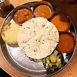 Round combination plates serving Indian food