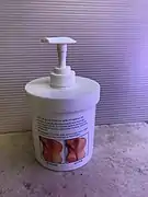 Jar of skin cream with dispenser