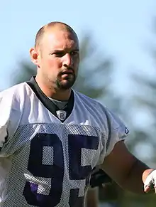 An American football player wearing a white jersey with the number 95 across the chest.