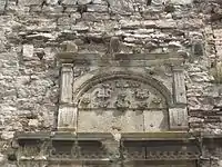 tympanum with the Jazłowiecki Abdank coat of arms on fortress wall