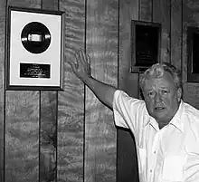 Miller with a gold record awarded to Kitty Wells