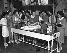 Jeanne Voltz, billed as Marian Manners, teaching a group of Japanese-American women to make pie