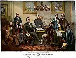 Six men sitting around a table looking forward, one man, Robert E. Lee, is standing up pointing toward a map