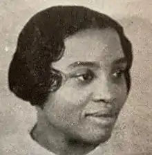 Portrait of an African American woman with short hair facing right.