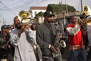 The Stooges Brass Band playing for the Lady Jetsetters second line in 2009. From left to right, Alfred Growe (trombone), Virgil Tiller (tenor sax), and Drew Baham (trumpet). Photo by Derek Bridges.