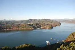 Elongated reservoir lined by hills