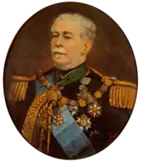 Half-length painted portrait depicting a gray-haired man with moustache wearing a military tunic with epaulettes, lanyards, blue sash, and several medals and orders on his breast and at his neck