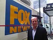 Peyronnin standing next to the first satellite truck owned by FOX News in 1995