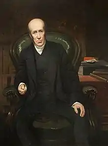 Seated painted portrait on a chair of John Clay, with books on a table