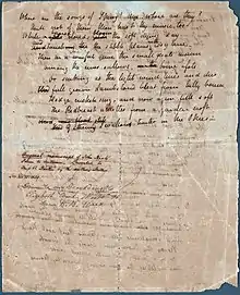 A white sheet of paper that is completely filled with a poem in cursive hand writing. A few of the words are scratched out with other words written above as corrections. Words can be partly seen from the other side of the page but they are illegible. A note midway down the page describes that it is an "Original manuscript of John Keats's Poem to Autumn."