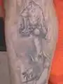 Tattoo on John Parsons' left leg depicts a naked woman.