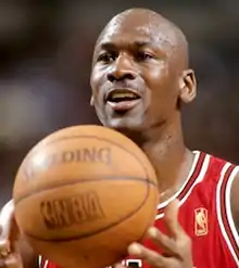 Head shot of a bald black man looking left