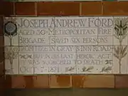 A tablet formed of five tiles of varying sizes, bordered by yellow and blue flowers in an art nouveau style