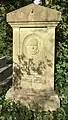 Grave of Joseph Edwards in Highgate Cemetery, set in ivy-covered surrounds, with his bas-relief portrait