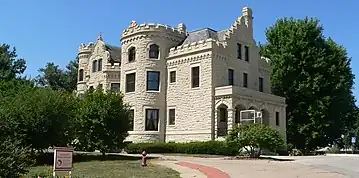 Three-story stone building with crenellated roofline