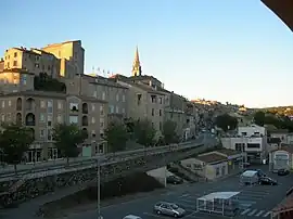 The railway station car park and the D104 road, with the chateau and the church beyond