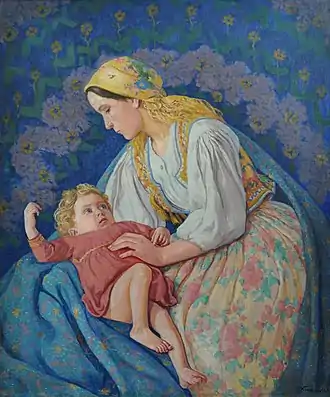 Woman on blue cloth holding a baby