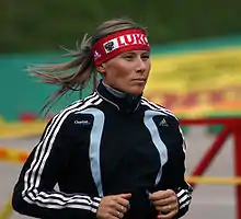 Yuliya Chepalova running in a track suit. She was later found guilty of doping in 2006.