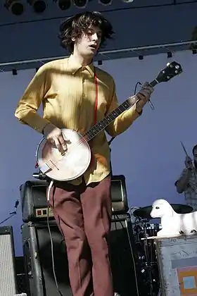 Koster playing the banjo at ArthurFest 2005 (signature lamb-lamp seen in background)