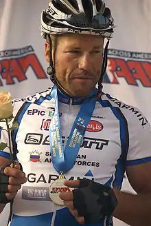male cyclist standing on a winner's podium