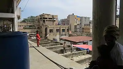 Kids playing on one of the concrete awnings above an entrance