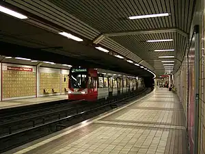 White-and-red train pulls in to underground platform