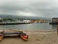 The small beach is protected by the pier.