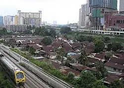 The northern half of Haji Abdullah Hukum Village (as of August 2007), as seen from the Abdullah Hukum LRT station and with the incomplete Gardens shopping centre to the right. By 2008, much of the village was cleared away for a further expansion of the Mid Valley City development project.