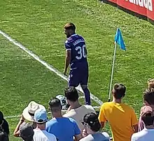 A player on the pitch looking at the match from a corner