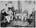 Surrender of the Crown Prince of the Sultanate of "MartaNingrat", Djambi (Jambi), in Sumatra before the Dutch residency official O.L. Helfrich, who takes the insignia in reception (March 26, 1904)