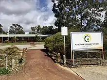 School entrance with a sign to the right