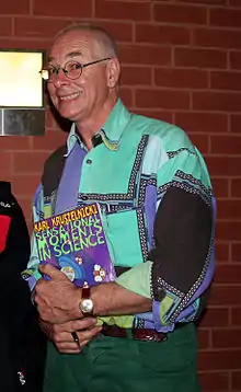 Kruszelnicki holding a copy of his book Sensational Moments in Science