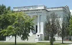 Facade of imposing building with Greek columns.