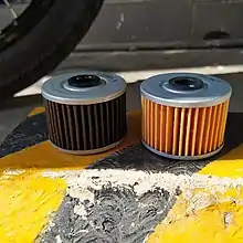 Motorcycle oil filters on Kawasaki W175. Old (left) and new (right).